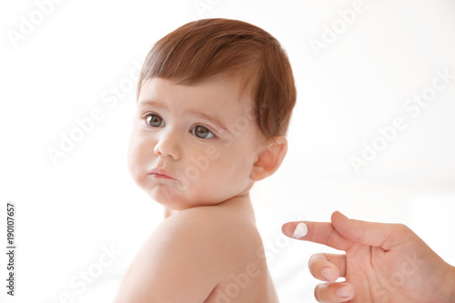 Woman applying body cream o...