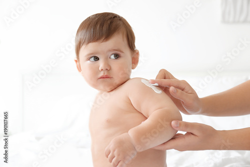 Woman applying body cream o...