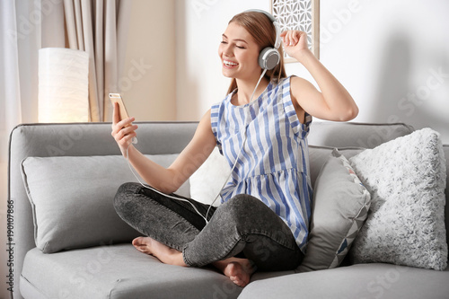Young woman listening to mu...