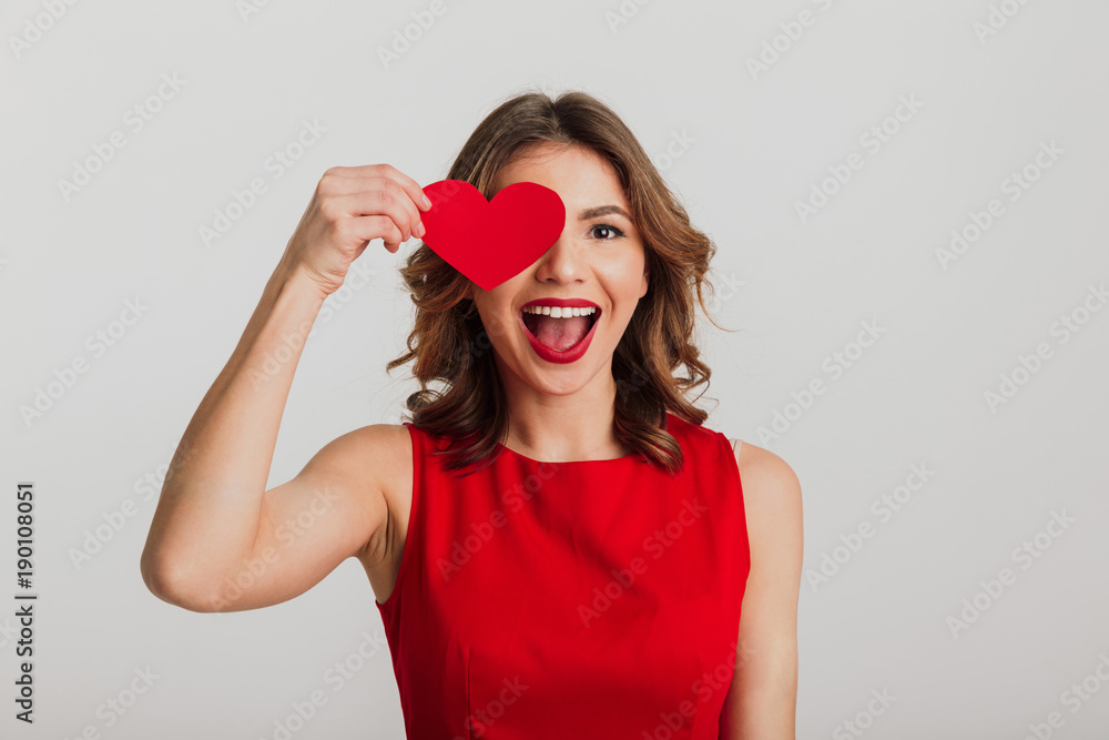 Portrait of a cheerful young woman dressed in red dress - obrazy, fototapety, plakaty 
