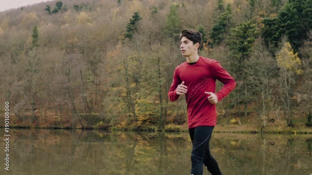 Young handsome man running in autumn nature. Young handsome man running in autumn nature.