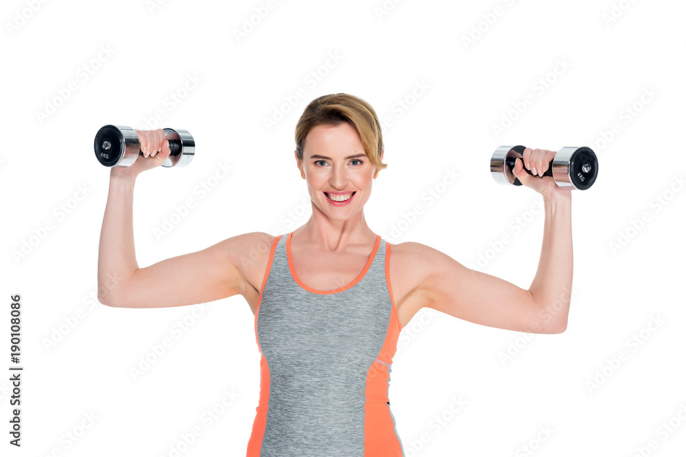 portrait of smiling woman in sportswear exercising with dumbbells isolated on white portrait of smiling woman in sportswear exercising with dumbbells isolated on white