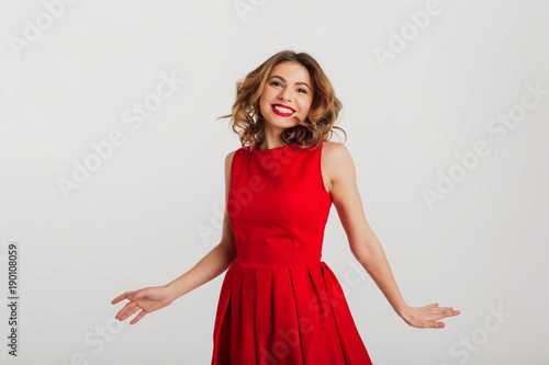 Portrait of a happy young woman dressed in red dress