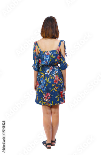 back view of standing young beautiful  woman.  girl  watching. Rear view people collection.  backside view of person.  A girl in a colorful dress is worth her hands down. © ghoststone