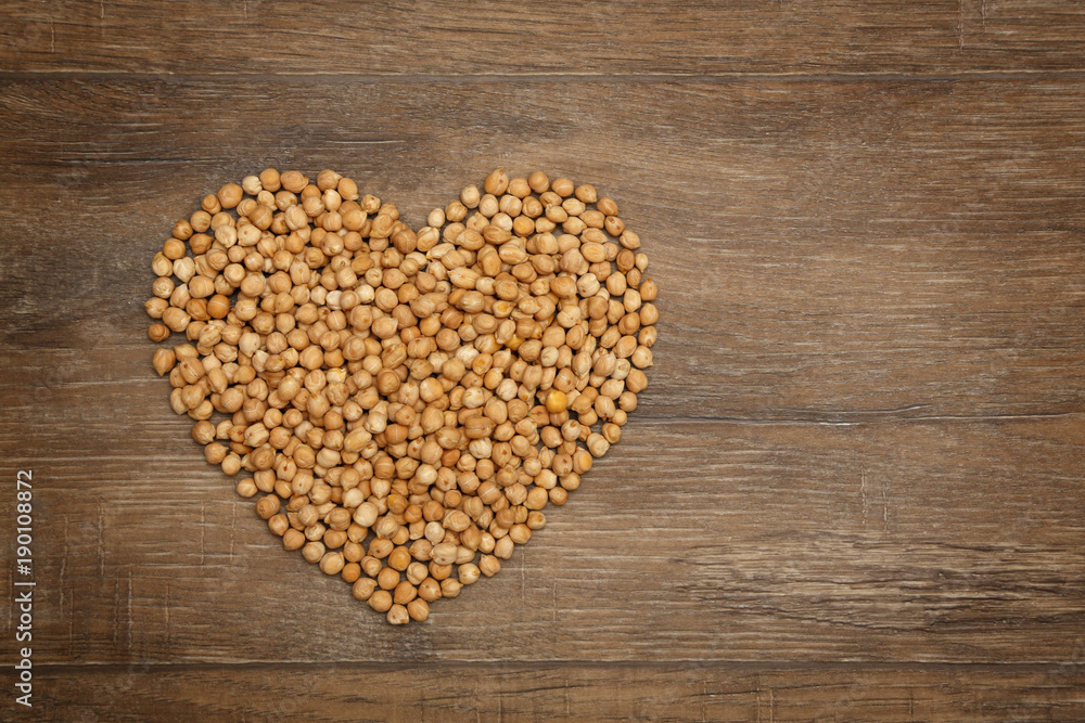 Heart of chickpeas on brown wooden table Heart of chickpeas on brown wooden table