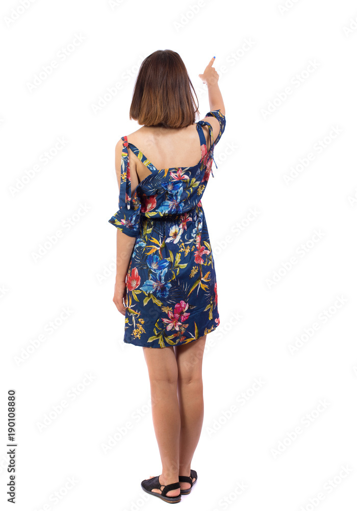 Back view of pointing woman. beautiful girl. Rear view people collection. backside view of person. Isolated over white background. The girl in a colorful dress shows her finger forward Back view of pointing woman. beautiful girl. Rear view people collection. backside view of person. Isolated over white background. The girl in a colorful dress shows her finger forward