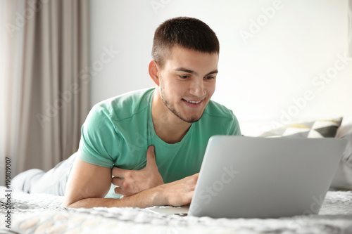 Young man using laptop at home