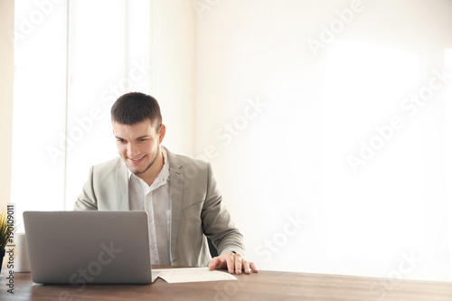 Young man using laptop at home