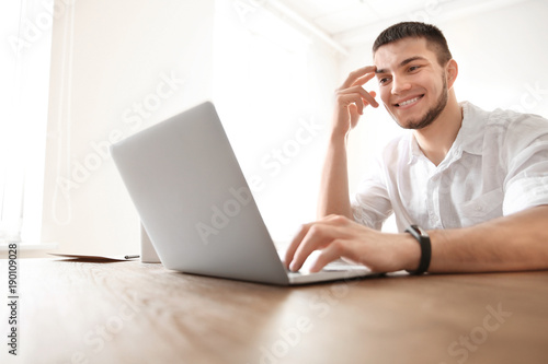 Young man using laptop at home