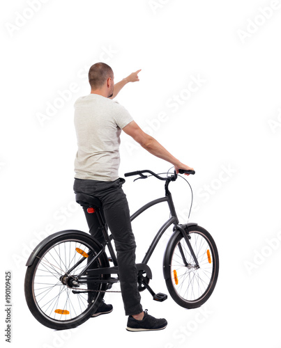 back view of pointing man with a bicycle.