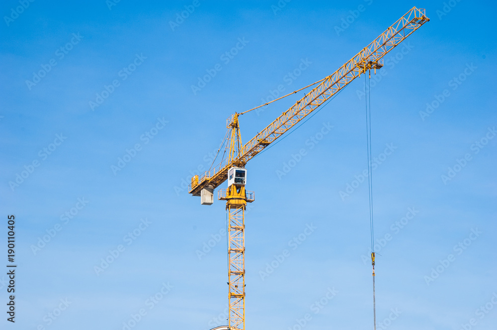 Building crane near a multi-storey residential building.
