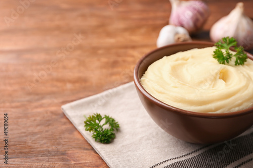 Bowl with mashed potatoes on table