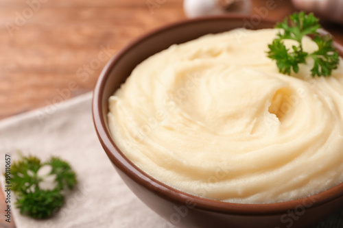 Bowl with mashed potatoes on table