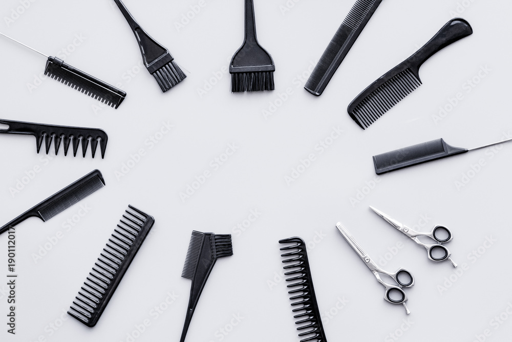 Beauty saloon equipment. Hairdress, haircut. Combs, sciccors, brushes on grey background top view copy space