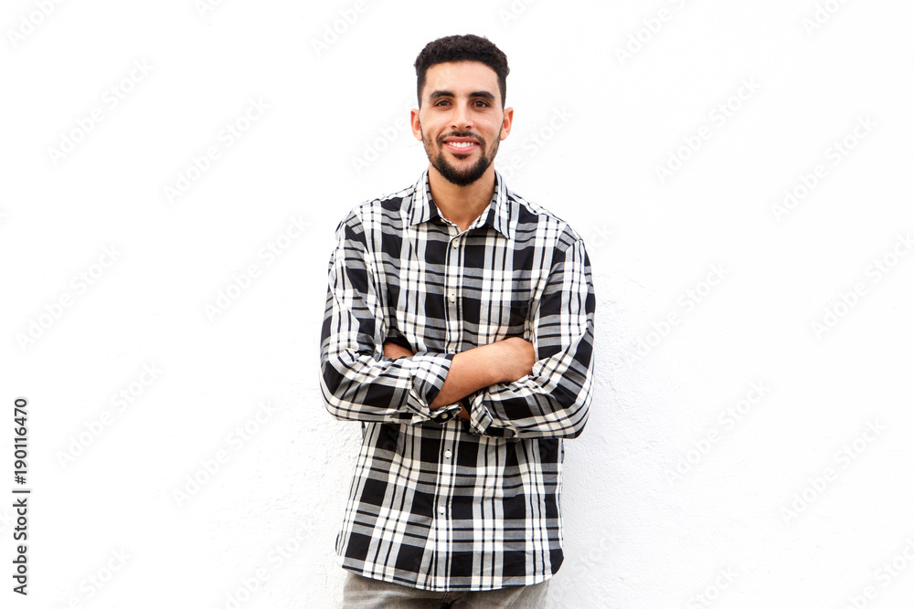 North African man smiling against white background with arms crossed North African man smiling against white background with arms crossed