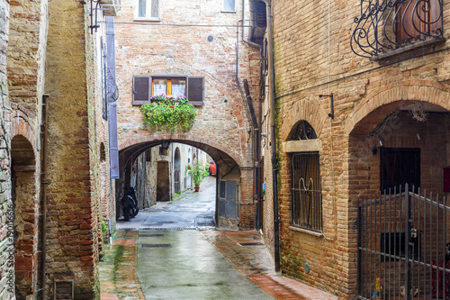 Back street in an old Italian town with iron gate
