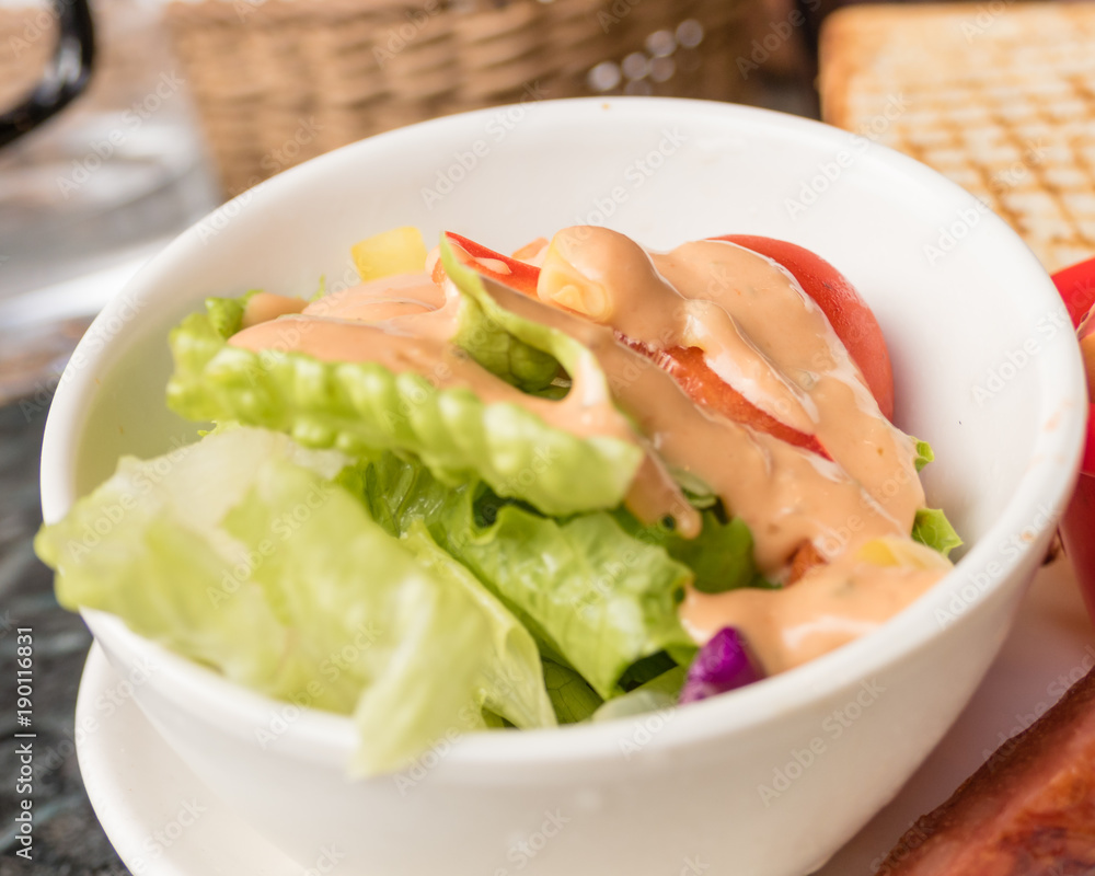 Salad in small bowl with pink dressing Salad in small bowl with pink dressing