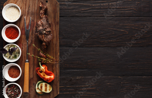 Grilled meat and vegetables on rustic wooden board