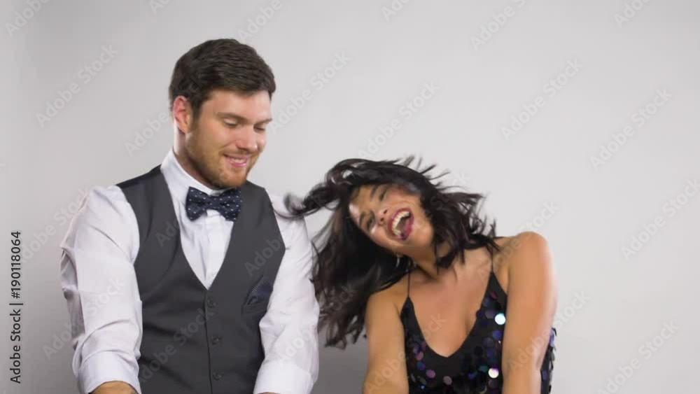 happy couple with sparklers dancing at party