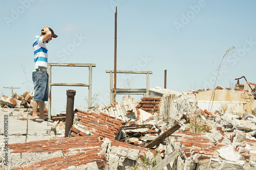 Man observing the destruction of his home.