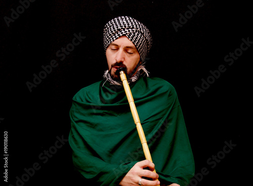 Muslim man with turban playing ney - Traditional sufi music