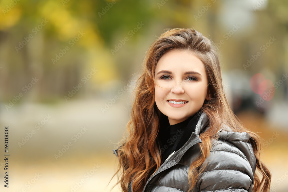 Beautiful smiling woman in puffer jacket outdoors Beautiful smiling woman in puffer jacket outdoors
