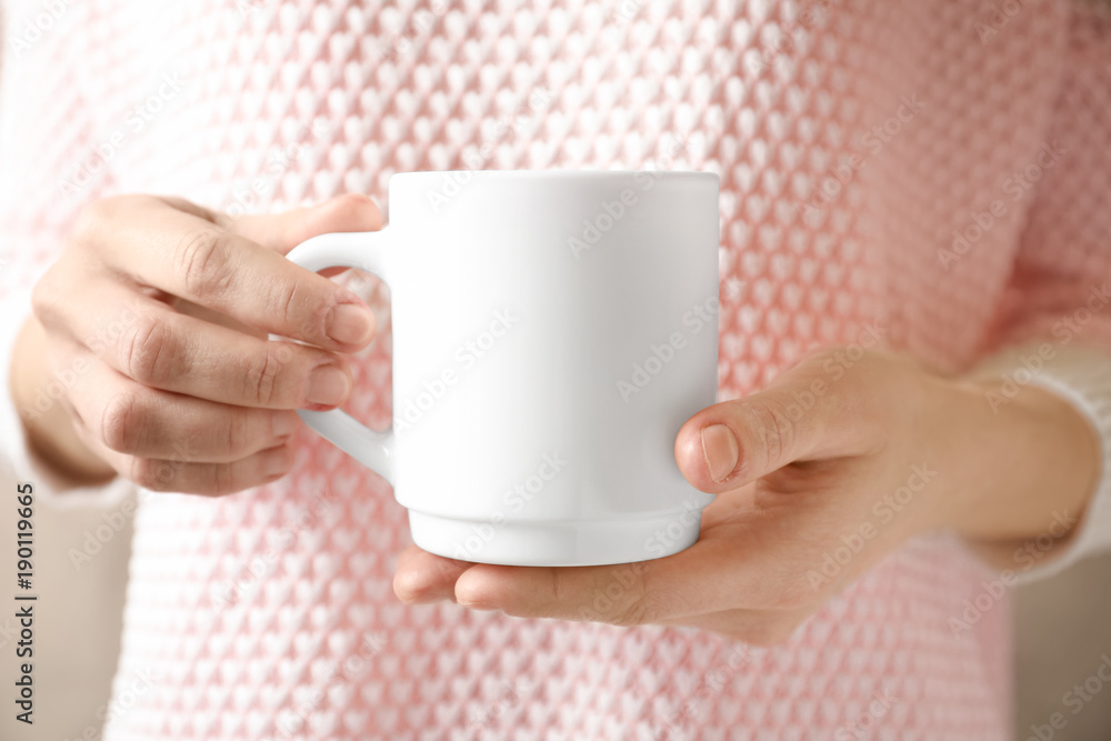 Woman holding ceramic cup, closeup. Mockup for design Woman holding ceramic cup, closeup. Mockup for design