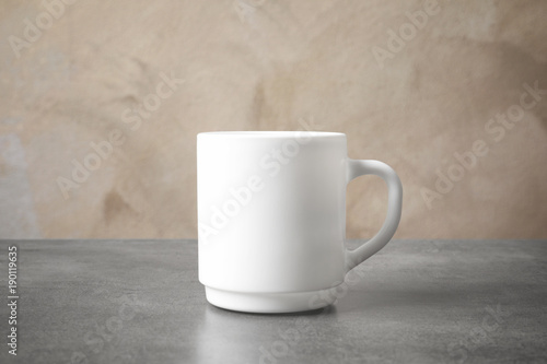 Ceramic cup on table. Mockup for design