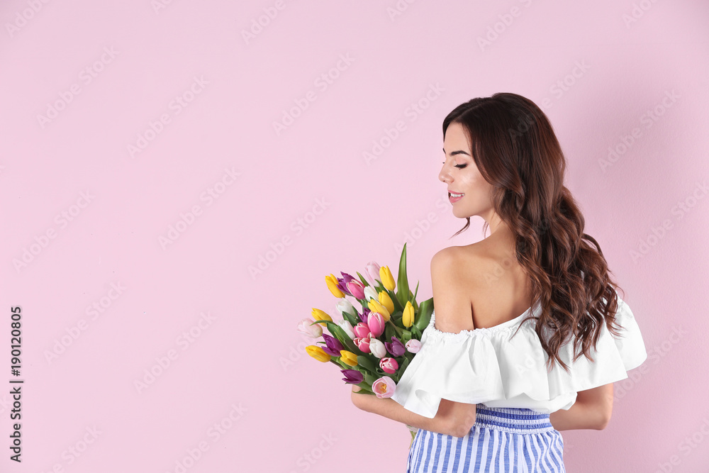 Beautiful woman holding bouquet of tulips on color background Beautiful woman holding bouquet of tulips on color background
