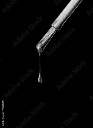 silver grey nail polish brush on black background.jpg