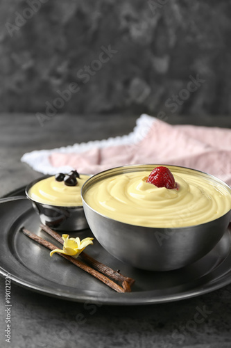 Bowls with tasty vanilla pudding on table