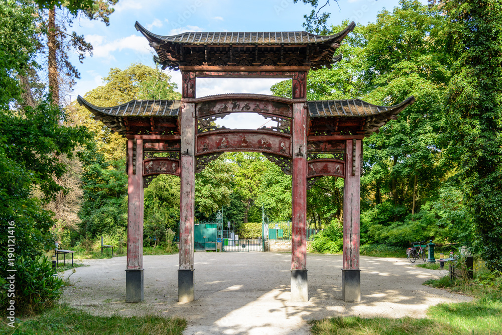 Rear view of the old wooden chinese gateway standing at the main entrance of the garden of tropical agronomy in Paris. Rear view of the old wooden chinese gateway standing at the main entrance of the garden of tropical agronomy in Paris.
