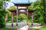 Rear view of the old wooden chinese gateway standing at the main entrance of the garden of tropical agronomy in Paris.