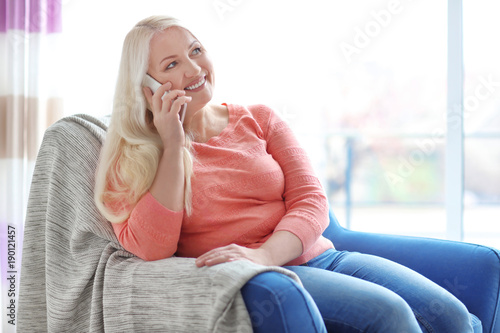 Happy mature woman talking ...