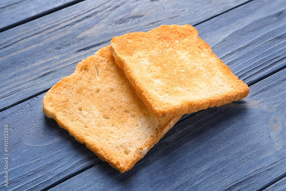 Toasted bread on wooden background