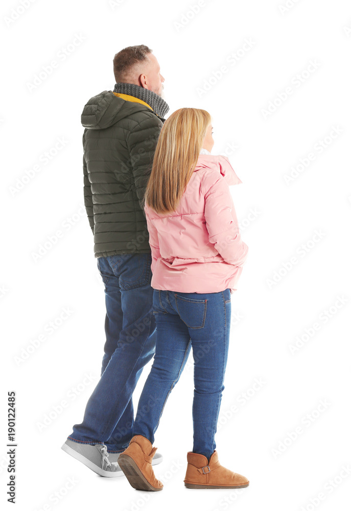 Mature couple in warm clothes walking on white background Mature couple in warm clothes walking on white background