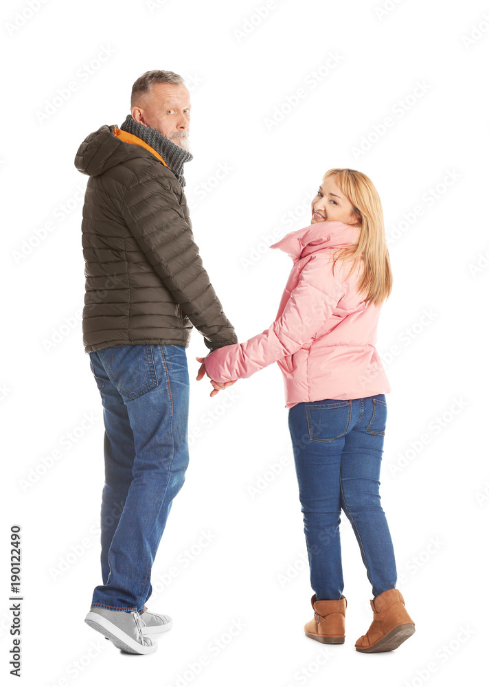 Mature couple in warm clothes walking on white background Mature couple in warm clothes walking on white background