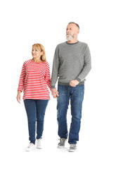 Mature couple in casual clothes walking on white background