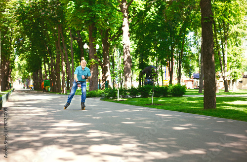Wallpaper Mural Senior man roller skating outdoors Torontodigital.ca