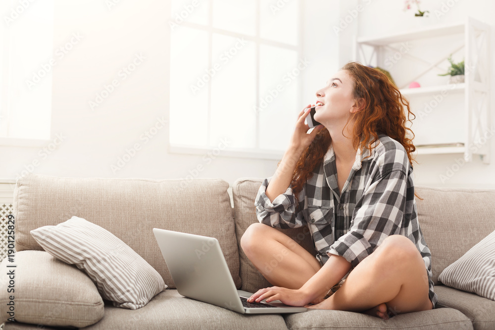 Girl with laptop and mobile sitting on beige couch. Girl with laptop and mobile sitting on beige couch.