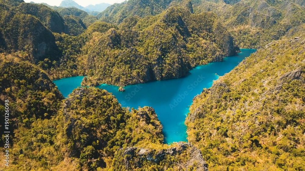 Aerial view:Mountain Kayangan lake,on a tropical island with blue water. Lake in the mountains covered with tropical forest on the island Coron, Palawan, Philippines. Travel concept