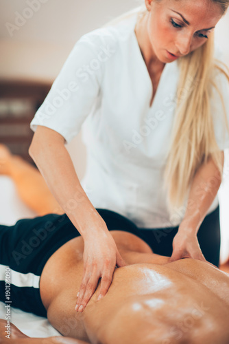 Sports massage. Therapist massaging sportsman's back
