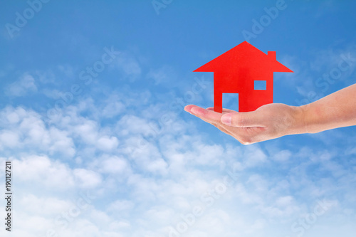 Man Holding House on sky