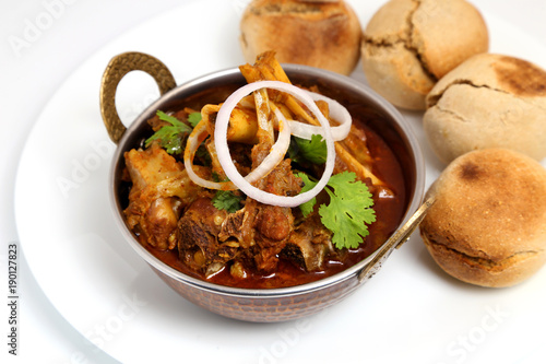 Indian or Rajasthani non veg food. Indian style meat dish or mutton curry with bati.