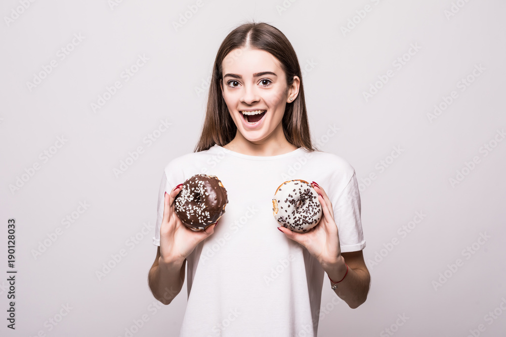 Pretty woman with two glazed donuts on white background. Health concept. Pretty woman with two glazed donuts on white background. Health concept.