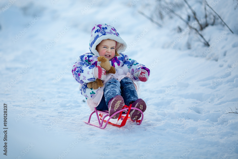 Winter Walk of small pretty ruddy girl, child plays with soft toy Winter Walk of small pretty ruddy girl, child plays with soft toy
