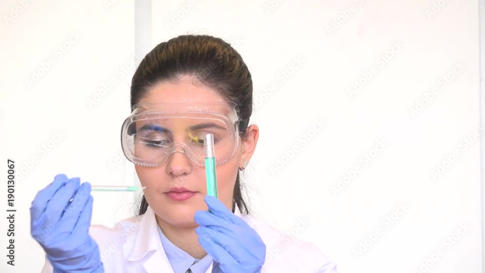 Close up face lab researcher chemist female portrait work with pipette test tube Close up face lab researcher chemist female portrait work with pipette test tube