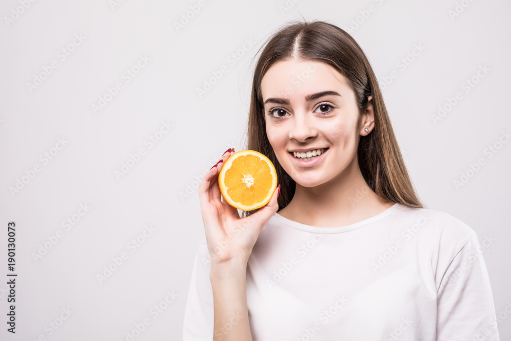 portrait of attractive caucasian smiling woman with orange isolated on white background. Health concept. portrait of attractive caucasian smiling woman with orange isolated on white background. Health concept.