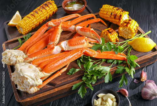 Crab legs served with melted butter photo