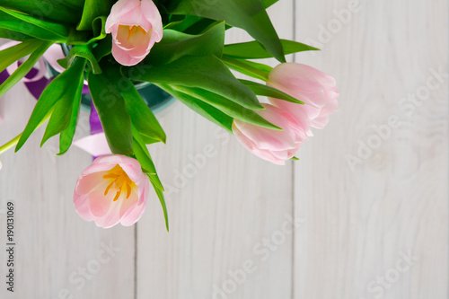 Fototapeta Naklejka Na Ścianę i Meble -  Pink tulips bouquet on white wood background, top view